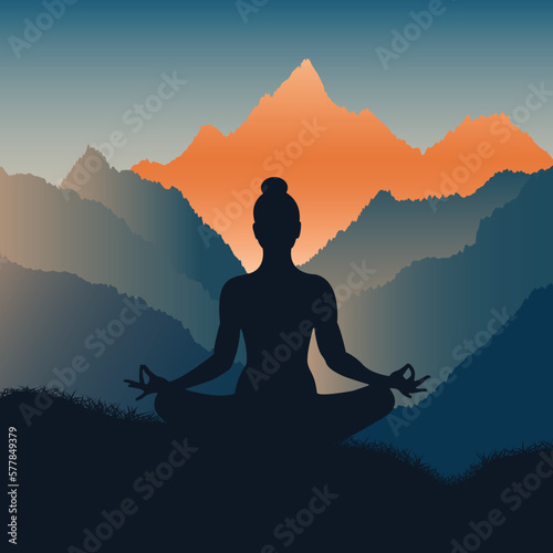 Silhouette of a woman meditating in the mountains at beautiful sunrise