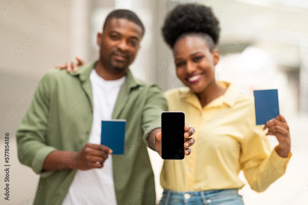 Cheerful African American Spouses Showing Phone Advertising Travel App Outside