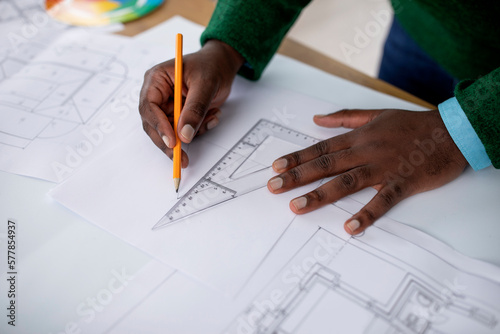 Closeup Of Black Male Designer Working Drawing Plan At Workplace