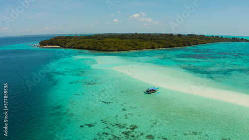 Travel concept: sandy beach on a tropical island by coral reef atoll from above. Mansalangan sandbar, Balabac, Palawan, Philippines. Summer and travel vacation concept
