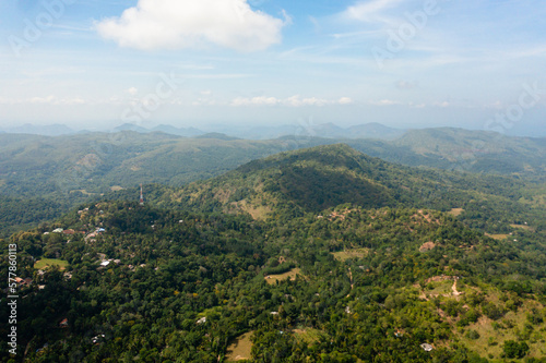 Aerial view of Mountains with rainforest and clouds. Sri Lanka. Slopes of mountains with evergreen vegetation.