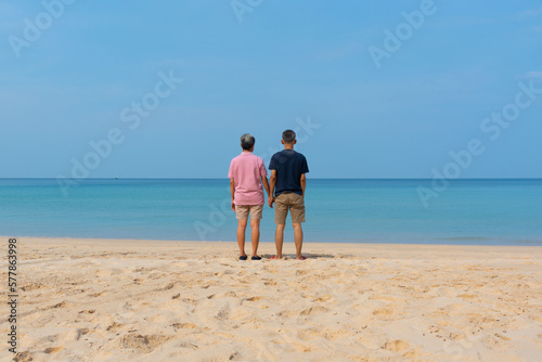 A couple of senior asian adults standing on the beach