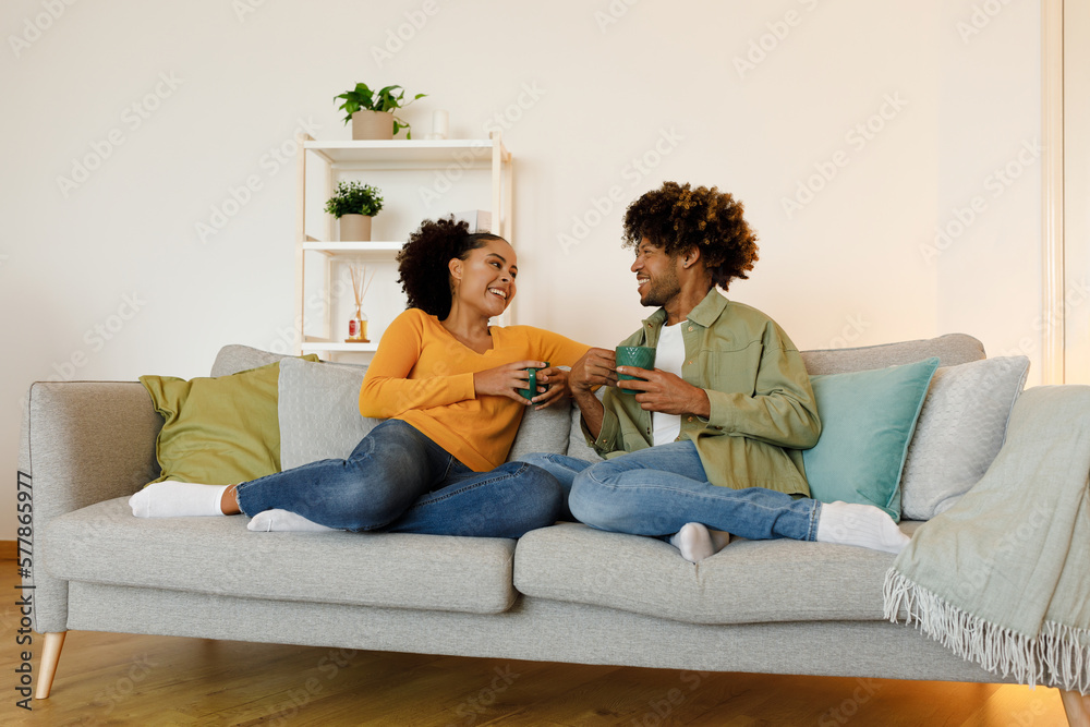 Happy Married Black Couple Talking And Drinking Coffee At Home Happy Married Black Couple Talking And Drinking Coffee At Home