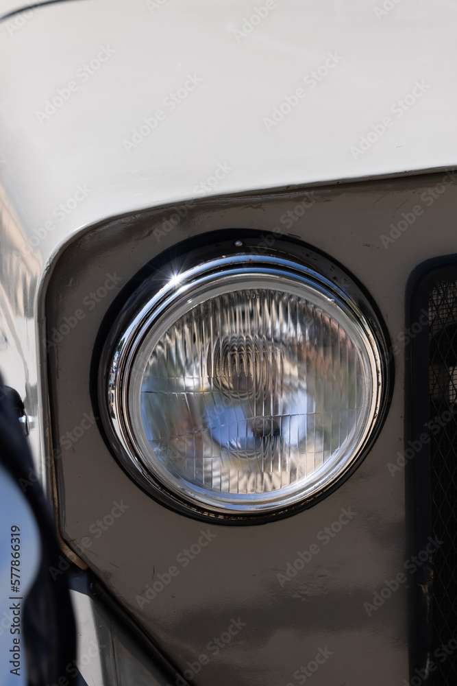  lamp attached to the front of a vehicle to illuminate the road ahead. Headlamps trucks are round and circular.Circular car headlights in the old style (vintage style). A round headlight from an old, 
