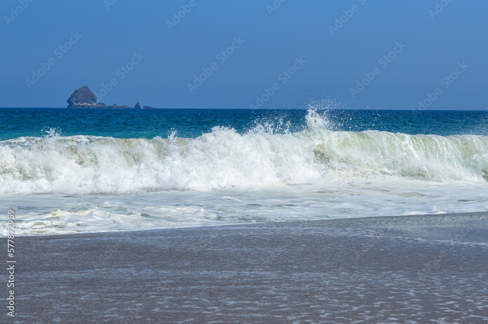 Beautiful sea waves with blue and turquoise color foam isolated on blue background Beautiful sea waves with blue and turquoise color foam isolated on blue background
