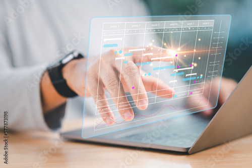 Project management concept, Analyst working with laptop in Business Analytics and Data Management System to make report with KPI and metrics connected to database. Corporate strategy for business 4.0