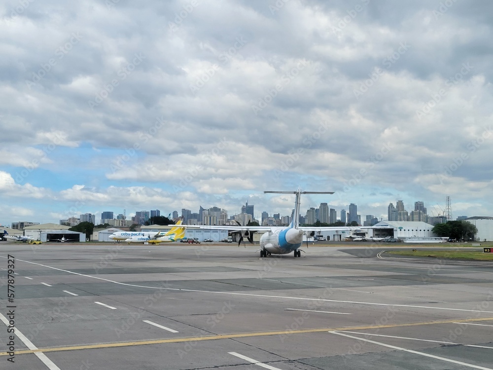 Cebu Pacific Propeller Aircraft and Manila Skyline at Ninoy Aquino