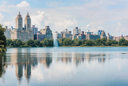 Fototapeta Naklejka Na Ścianę i Meble -  Central park lake view of New York City skyline in summer. USA travel vacation destination, reflection of buildings in water