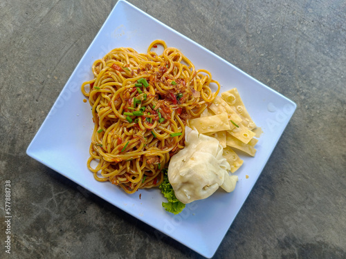 Noodle on white porcelain plate closeup flatlay