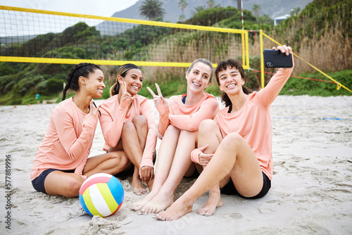 Volleyball, peace sign and friends take selfie at the beach after exercise, workout or training. Teamwork smile, sports and group of women or girls taking pictures with v hand emoji for happy memory