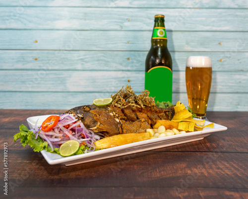 chita or fried fish with fried yucca and ceviche, with ice cold beer photo