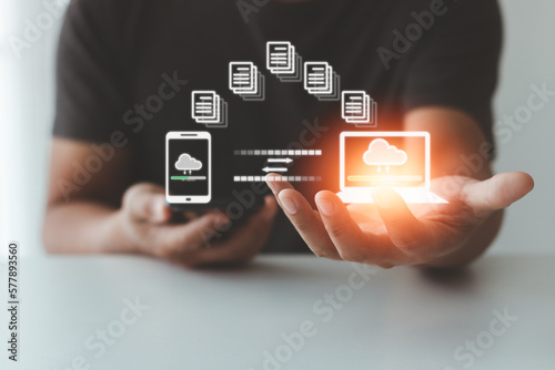 Man hand transfer file in screen, Smartphone and Laptop data transfer. Data transfer file between folder, Backup data, Exchange of file. Virtual document loading to another folder. Streaming download.
