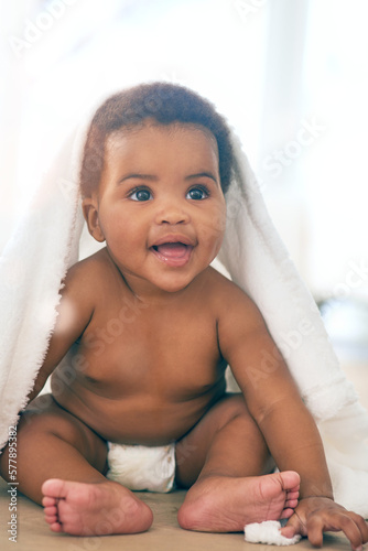фотографія Cute baby, black girl and blanket to play, game and peekaboo in nursery room, happiness and fun