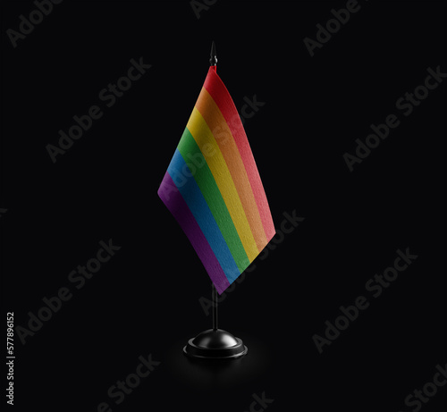 Small national flag of the lgbt on a black background