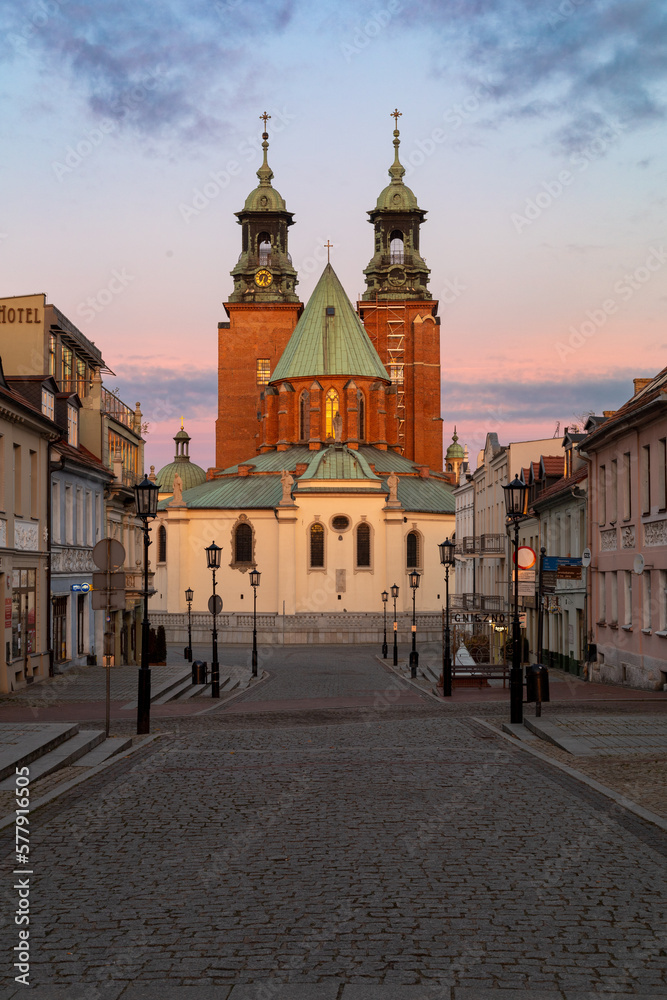 Fototapeta premium Historical road leading towards Gniezno Royal Cathedral on a sunset.