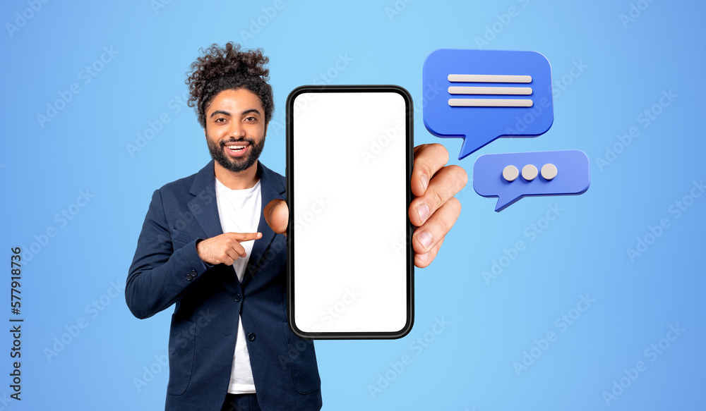 Middle eastern man with smartphone mockup display, text message bubbles Middle eastern man with smartphone mockup display, text message bubbles