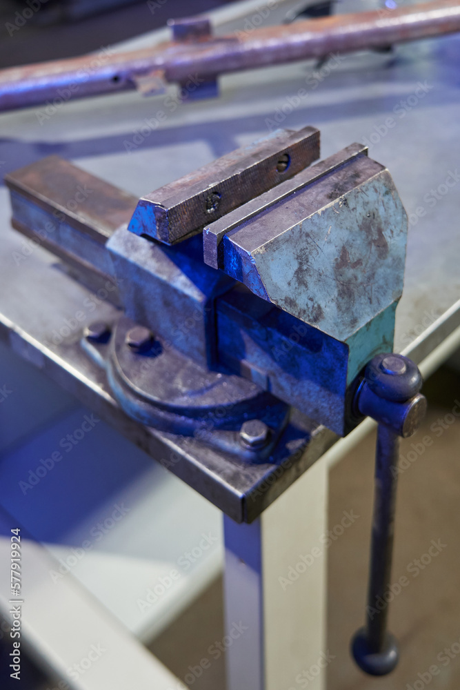 clamping bends are separated on a large metal cast-iron bench vise clamping bends are separated on a large metal cast-iron bench vise