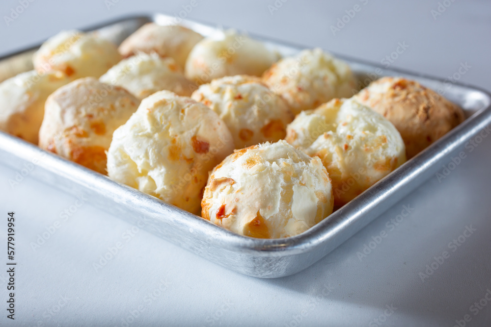 A view of a tray full of a Brazilian cheese bread known as Pão de queijo. A view of a tray full of a Brazilian cheese bread known as Pão de queijo.