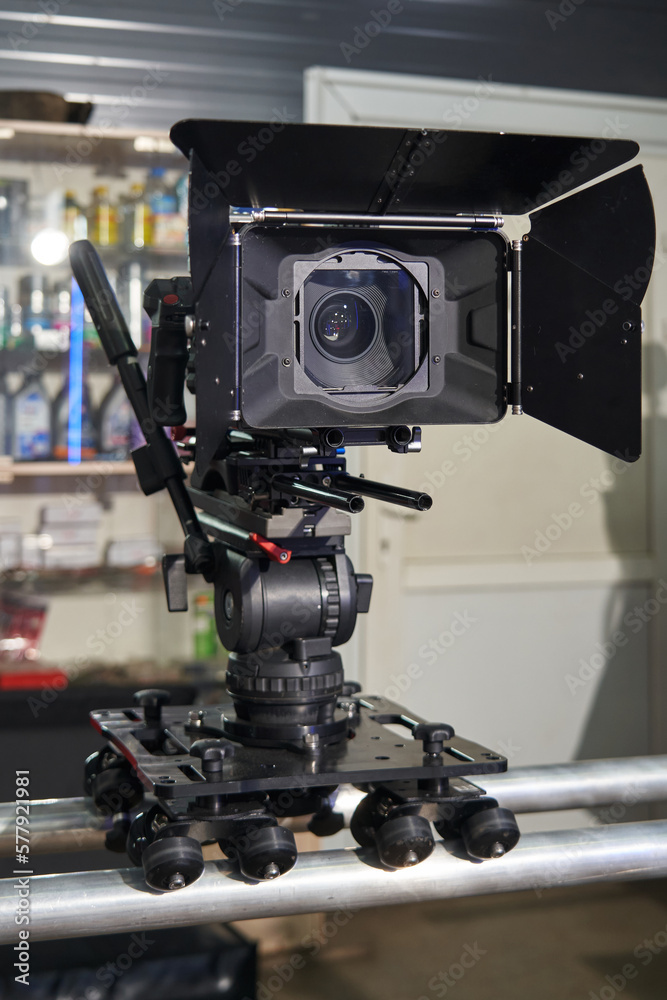 professional movie camera mounted on camera trolley and rails
