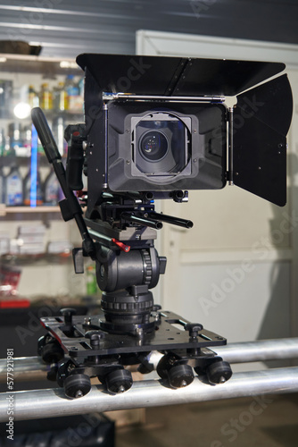 professional movie camera mounted on camera trolley and rails