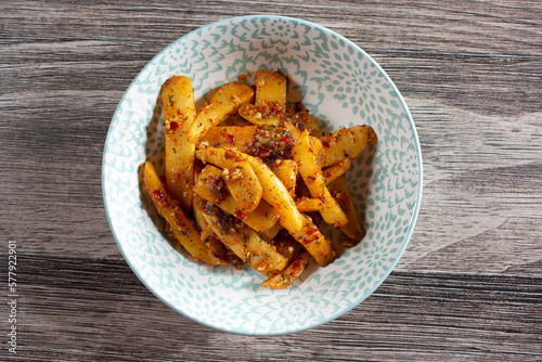 A top down view of a bowl of spicy garlic potatoes.