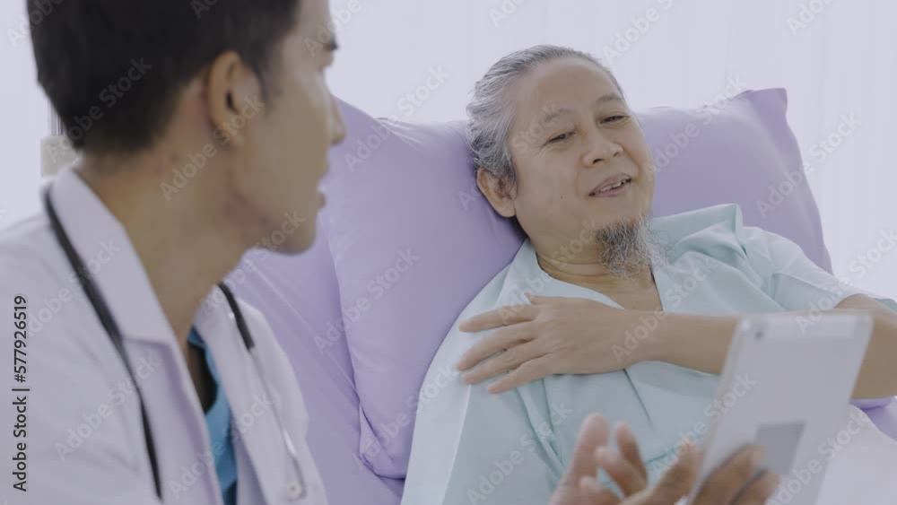 Doctor holding a tablet and talking to the patient. Practitioner doctor holding lungs radiography explaining disease expertise to sick patient during clinical consultation in hospital ward.