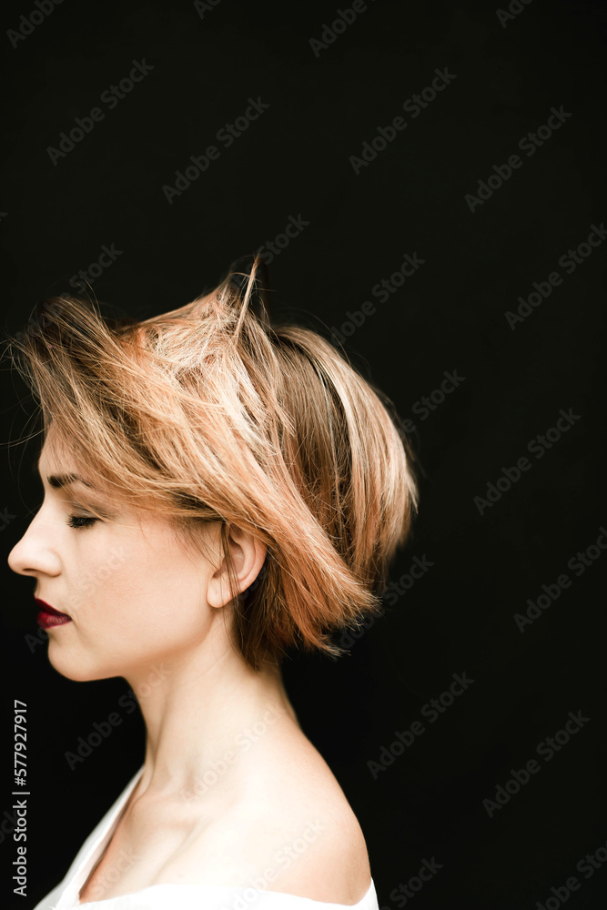 Portrait of attractive woman in profile against black background Portrait of attractive woman in profile against black background
