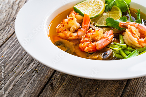 Thai seafood soup on wooden table 