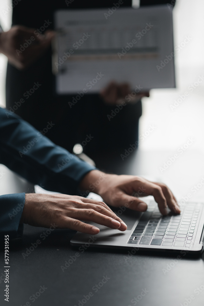 Person typing on laptop keyboard, businessman working on laptop, he is typing messages to colleagues and making financial information sheet to sum up the meeting. Person typing on laptop keyboard, businessman working on laptop, he is typing messages to colleagues and making financial information sheet to sum up the meeting.