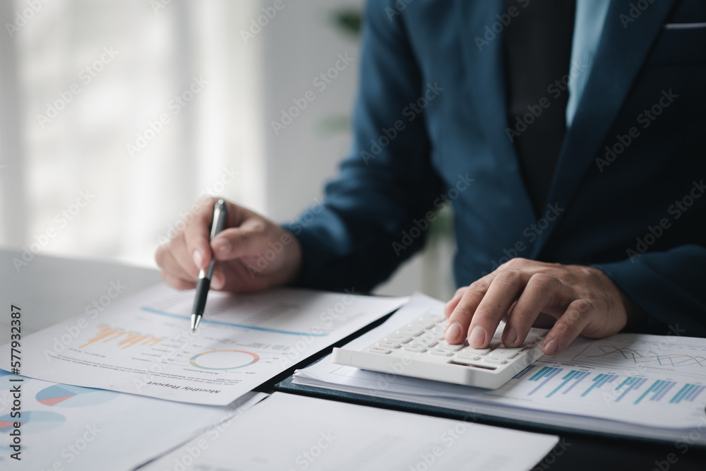 Business men are looking at the company's financial documents to analyze problems and find solutions before bringing the information to a meeting with a partner. Financial concept. Business men are looking at the company's financial documents to analyze problems and find solutions before bringing the information to a meeting with a partner. Financial concept.