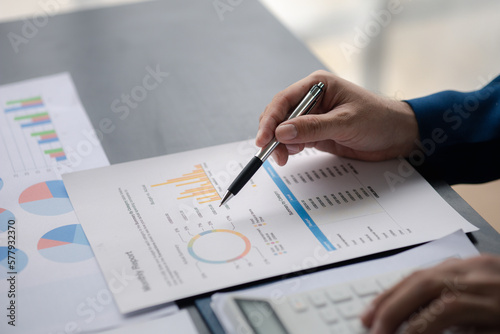 Business men are looking at the company's financial documents to analyze problems and find solutions before bringing the information to a meeting with a partner. Financial concept.