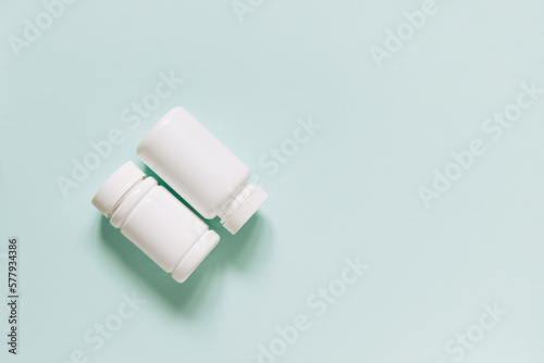 Set of various white medicines, mockup, pill bottles without label design, copy space on blue background 