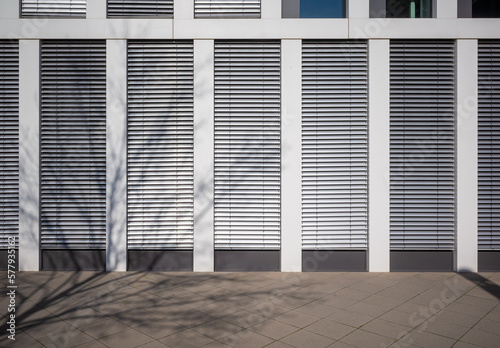 modern office building facade with closed automated exterior blinds