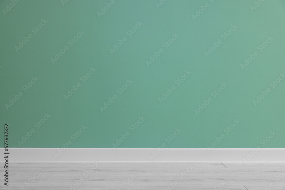 Beautiful light green wall and wooden floor in clean empty room Beautiful light green wall and wooden floor in clean empty room