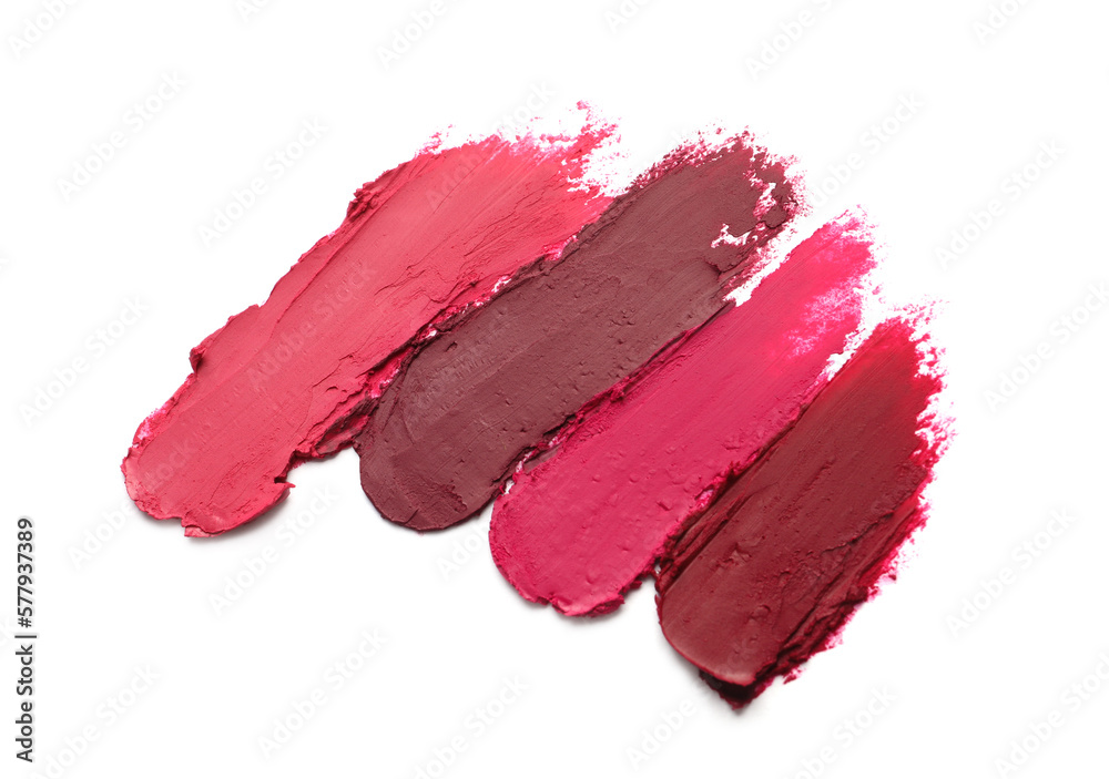 Fototapeta premium Smears of beautiful lipsticks on white background, top view