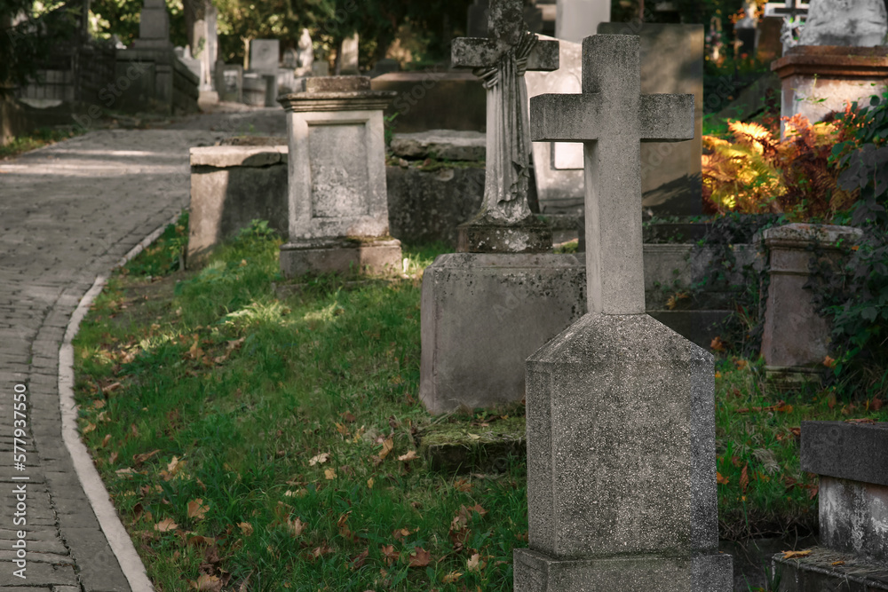 View of cemetery with granite tombstones and paved footpath on sunny day. Funeral ceremony View of cemetery with granite tombstones and paved footpath on sunny day. Funeral ceremony