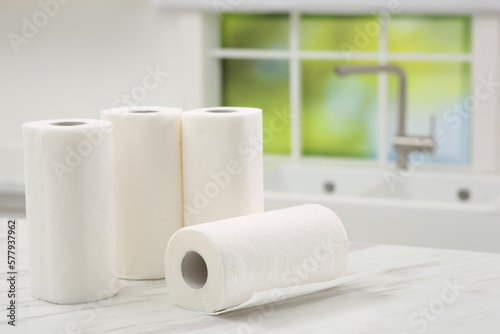 Many rolls of paper towels on white marble table in kitchen