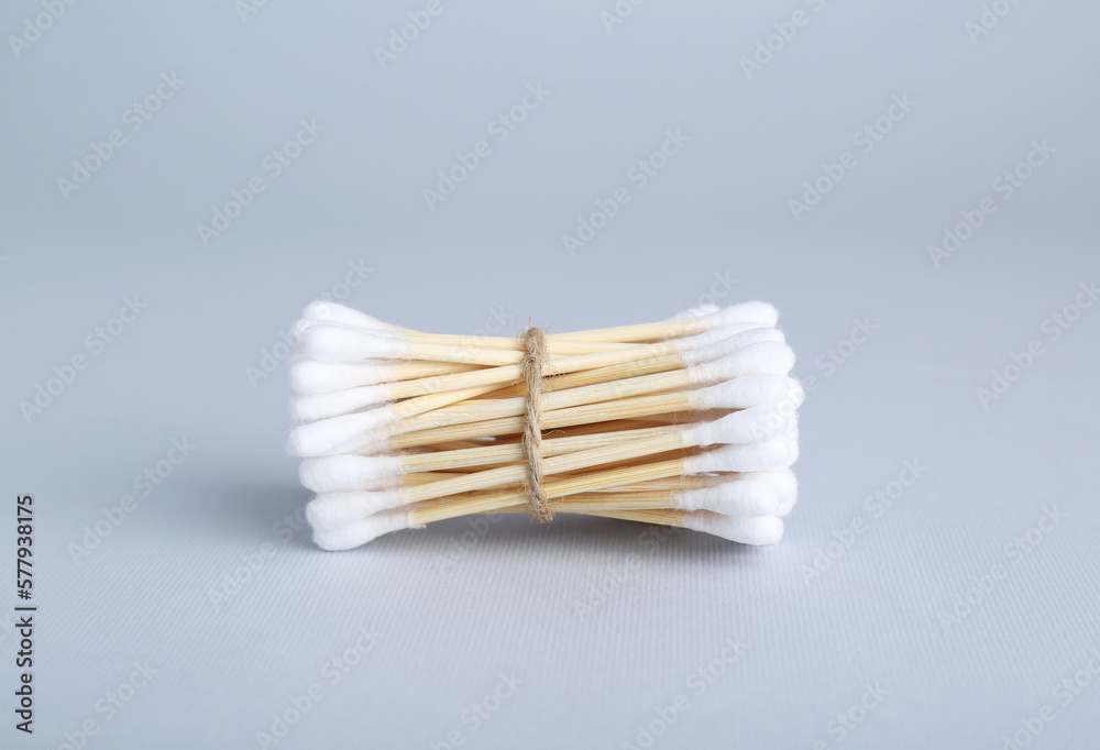 Bunch of wooden cotton buds on light grey background Bunch of wooden cotton buds on light grey background