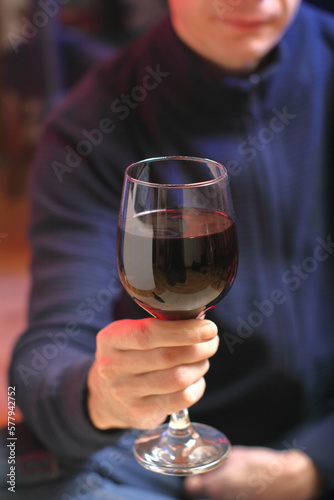 person holding a glass with wine