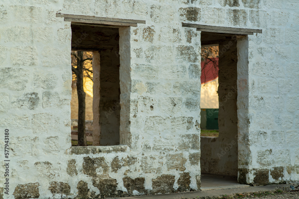 Brick facade building with no windows or door frames and white brcik exterior or facade in late afternoon shade evening Brick facade building with no windows or door frames and white brcik exterior or facade in late afternoon shade evening
