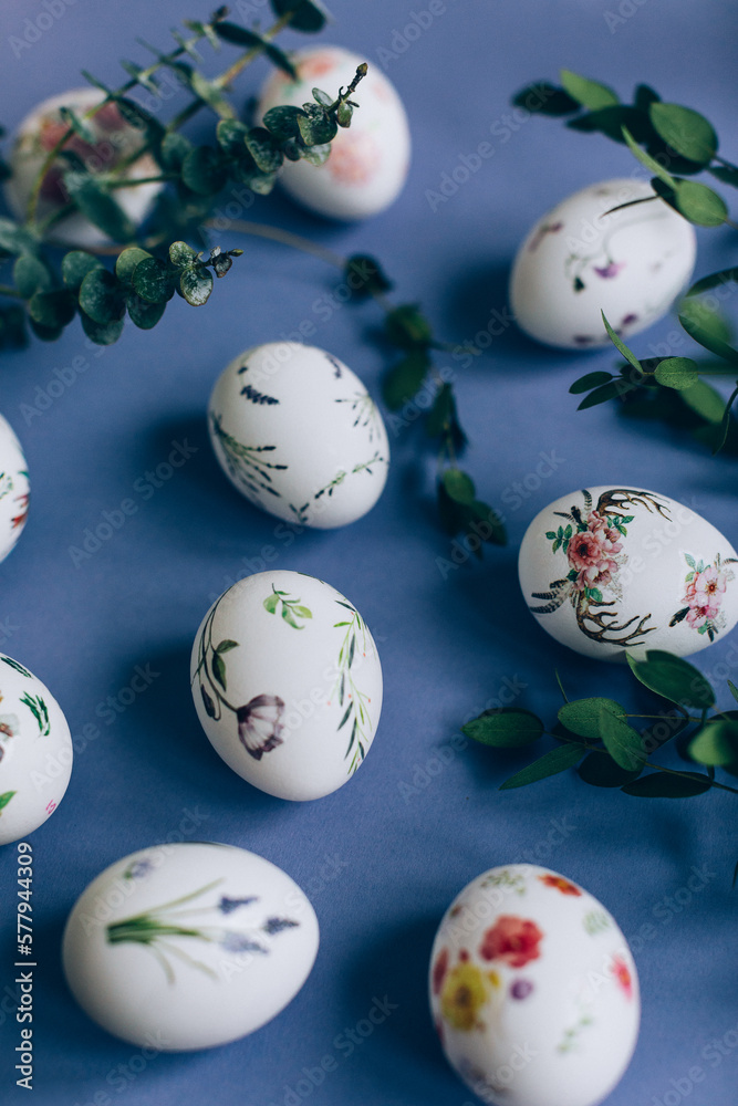 Easter eggs with floral ornament on blue table