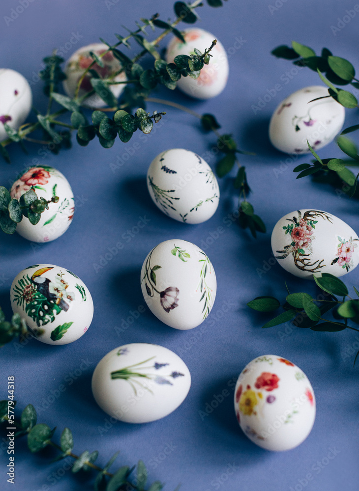 Easter eggs with floral ornament on blue table