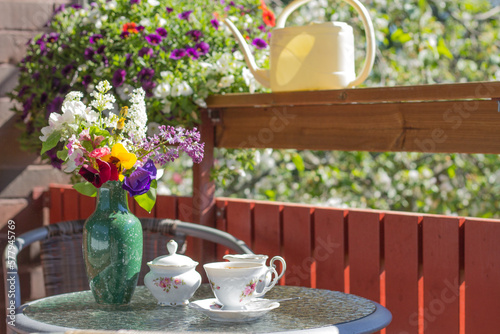 cofee set on the  cofee litle table in the banch in summer sunny day