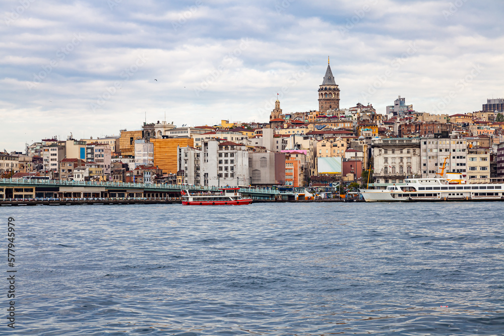 View of Galata Tower and Galata Bridge, the landmarks in Istanbul.  Cruise and sightseeing boats running in Bosphorus Straitat.