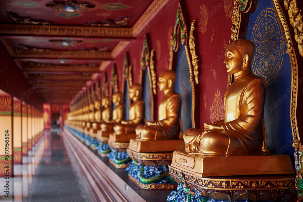 Many Golden statues of Buddha in thai temple.