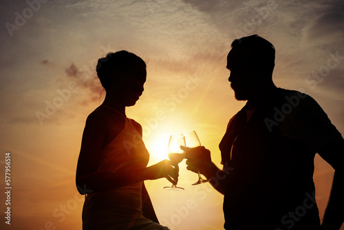 Senior business man and his wife celebrating on celebration event at the yacht deck,Silhouette romance scene marriage anniversary over sunset, luxury life and happiness moment, life insurance planning