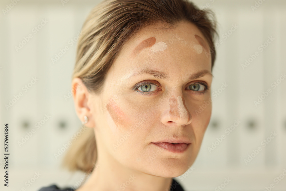 Skin tone cream lines on woman face close up. Skin tone cream lines on woman face close up.