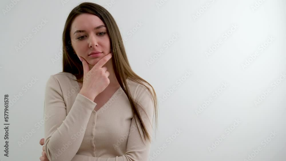 Portrait of Beautiful Thinking Woman Gesturing Brainstorming worries worried girl holding chin and thinking she has sad eyes beautiful young face stroking her chin raise her eyes Portrait of Beautiful Thinking Woman Gesturing Brainstorming worries worried girl holding chin and thinking she has sad eyes beautiful young face stroking her chin raise her eyes