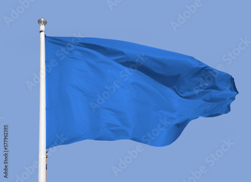 Close up of blue flag with sky background and copy space