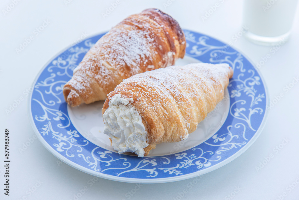 puff pastry cannoli filled with whipped cream, still life on white background , close-up